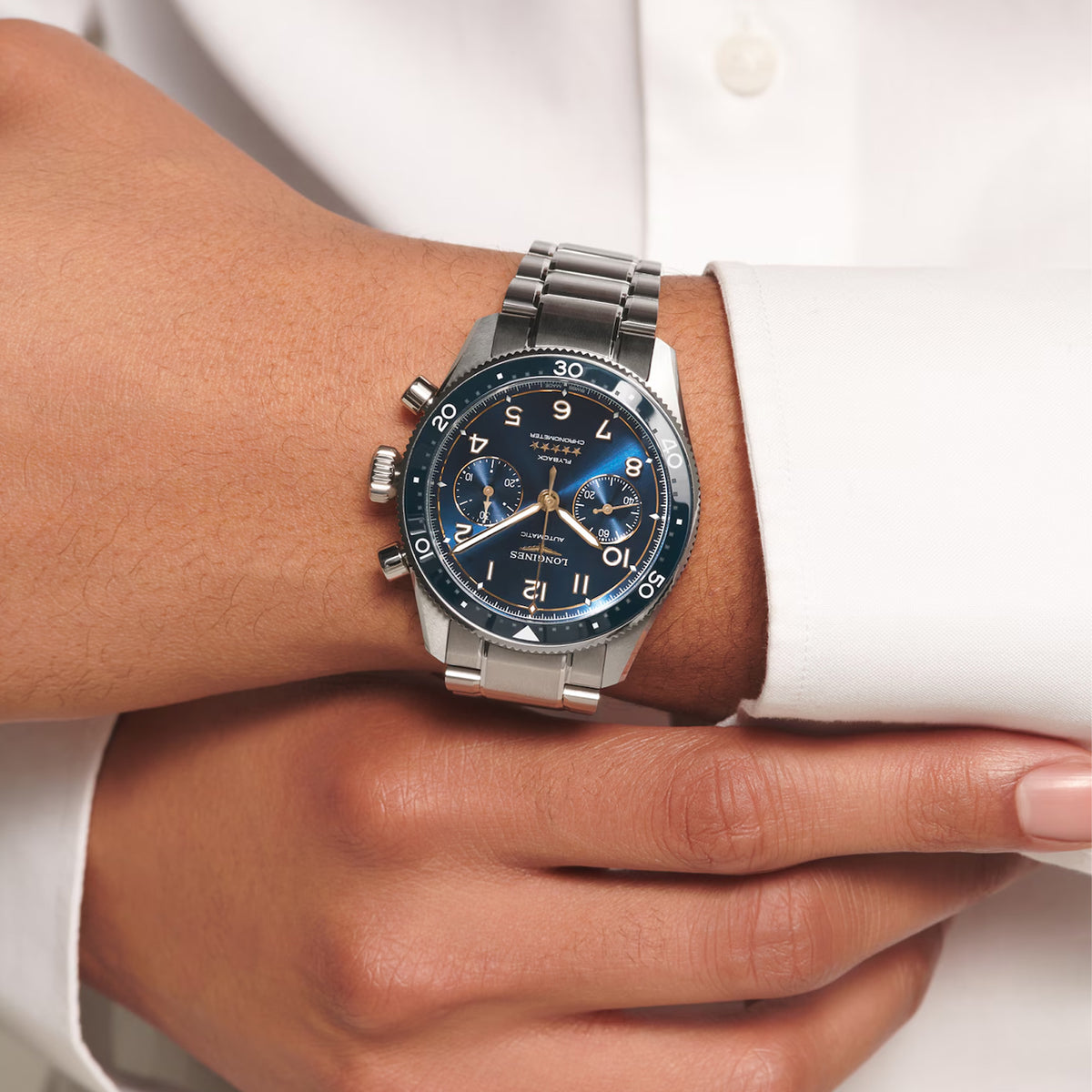 The Longines Spirit Flyback Automatic Chronograph Men's 42mm Watch L3.821.4.93.6 worn on the wrist, showing its pilot-inspired design and size. The blue dial and stainless steel bracelet give this Swiss chronograph a sporty look that suits everyday wear.