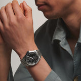 The Longines Conquest Men’s 41mm Automatic Watch L3.830.4.52.6 worn on the wrist, showing its versatile size and sporty style. The black dial and stainless steel bracelet make it easy to wear from the office to the weekend.
