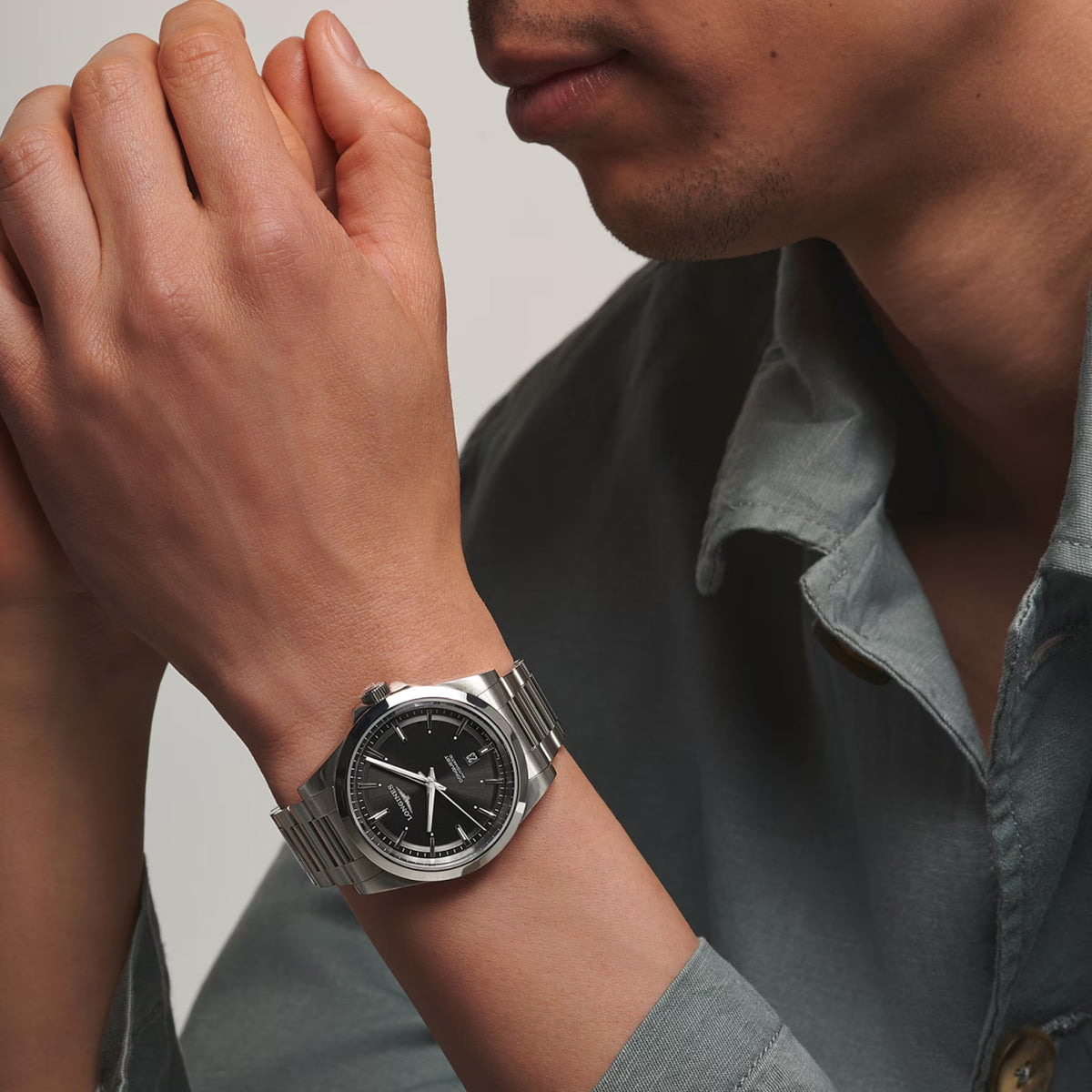 The Longines Conquest Men’s 41mm Automatic Watch L3.830.4.52.6 worn on the wrist, showing its versatile size and sporty style. The black dial and stainless steel bracelet make it easy to wear from the office to the weekend.
