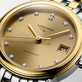 Close-up of the gold-tone dial on the Longines Flagship Classic Automatic Women’s 26mm Watch L4.274.3.37.7. The detail shows the hour markers, hands and date window beneath scratch-resistant sapphire crystal with anti-reflective coating.
