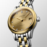 Three-quarter angle view of the Longines Flagship Classic Automatic Women’s 26mm Watch L4.274.3.37.7, showing the case profile, crown and gently curved lugs. The angle highlights the two-tone finish of the stainless steel and yellow PVD case.