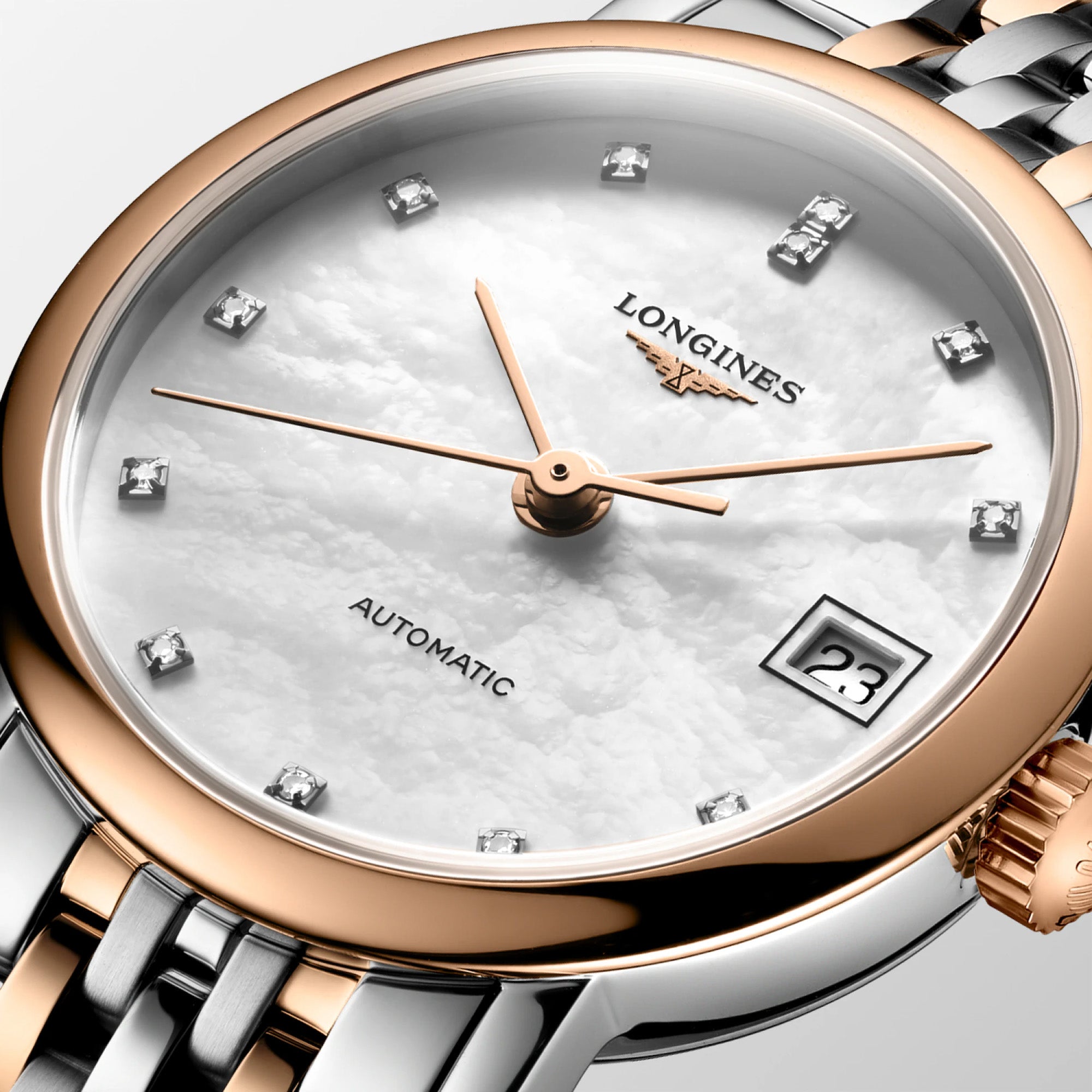 Close-up of the Longines Elegant Automatic dial, showcasing the luminous white mother-of-pearl finish and date display at 3 o'clock. Slim polished hands and refined hour markers reflect the watch's minimalist Swiss design.
