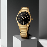 Three-quarter angle view of the Loyal Maritima Gold Watch, reference 05D47MBA1, lifestyle setting