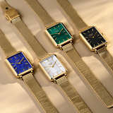 Four Loyal Academy Quartz Women’s 24.50mm watches, exclusive to Wallace Bishop, laid side by side, each with a Gold PVD rectangular case and a mesh bracelet. From left to right they are the Mother-of-Pearl dial, reference 20D4126, the Lapis Lazuli dial, reference 20D4128, the Black Onyx dial, reference 20D4127, and the Malachite dial, reference 20D4125.