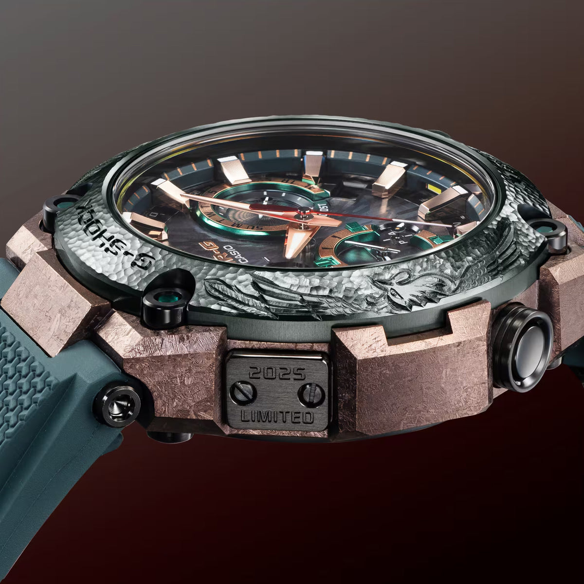 Side profile of the Casio G-SHOCK MRG-B2000KT-3A Limited Edition Men's Solar Watch, 49mm case, showing the titanium case depth and sapphire-coated screws. The blue-green Dura Soft rubber band is visible along the watch's profile.