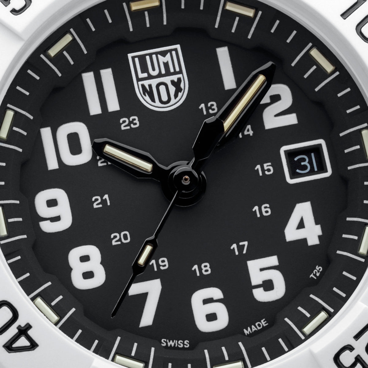 Close-up of a Luminox watch dial with a black face, large white Arabic numerals, black hands with silver tips, a date window at 3 o'clock, and a white bezel.