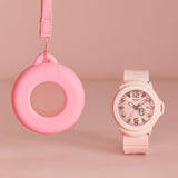 Casio Baby-G BGA15K-4A front view showcasing the soft pastel pink matte bezel and band with shimmering metal dial, pop-inspired rotating day display, and clean three-hand analogue face — the convertible Baby-G+PLUS watch that doubles as a bag charm.