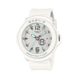 Casio Baby-G+PLUS BGA15K-7A front view, featuring a round white matte resin case and band with a shimmering metal dial with green accent detailing, Arabic numerals at 12 and 6 o'clock, rotating seven-design day display, and three analogue hands
