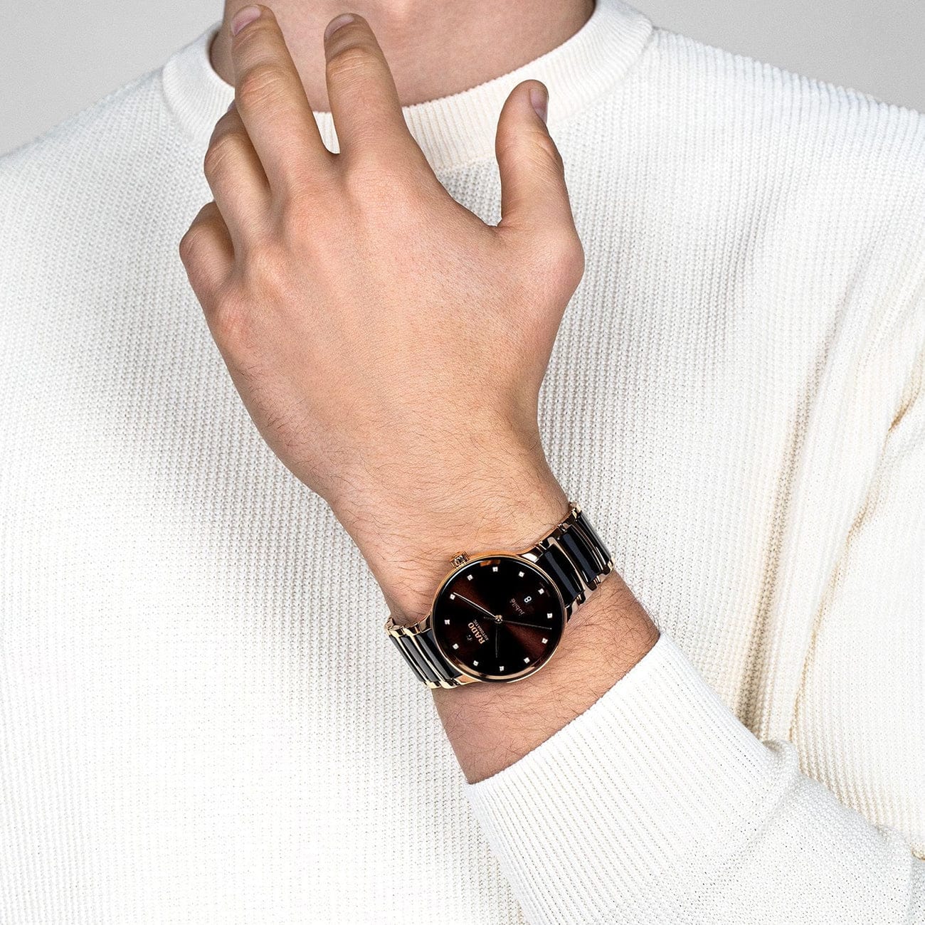 Rado Centrix Men's 39.5mm automatic watch featuring rose gold PVD stainless steel bracelet with brown high-tech ceramic details, brown dial, Sapphire Crystal, and Date Display - on wrist