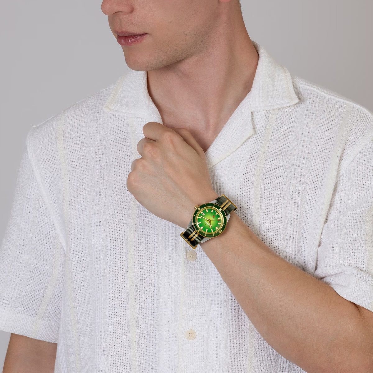 Rado Captain Cook x Cameron Green Limited Edition 42mm R32138318 worn on wrist with NATO strap – green sunray dial, gold bezel, green and yellow gold-coloured textile NATO-style strap in Australian colours