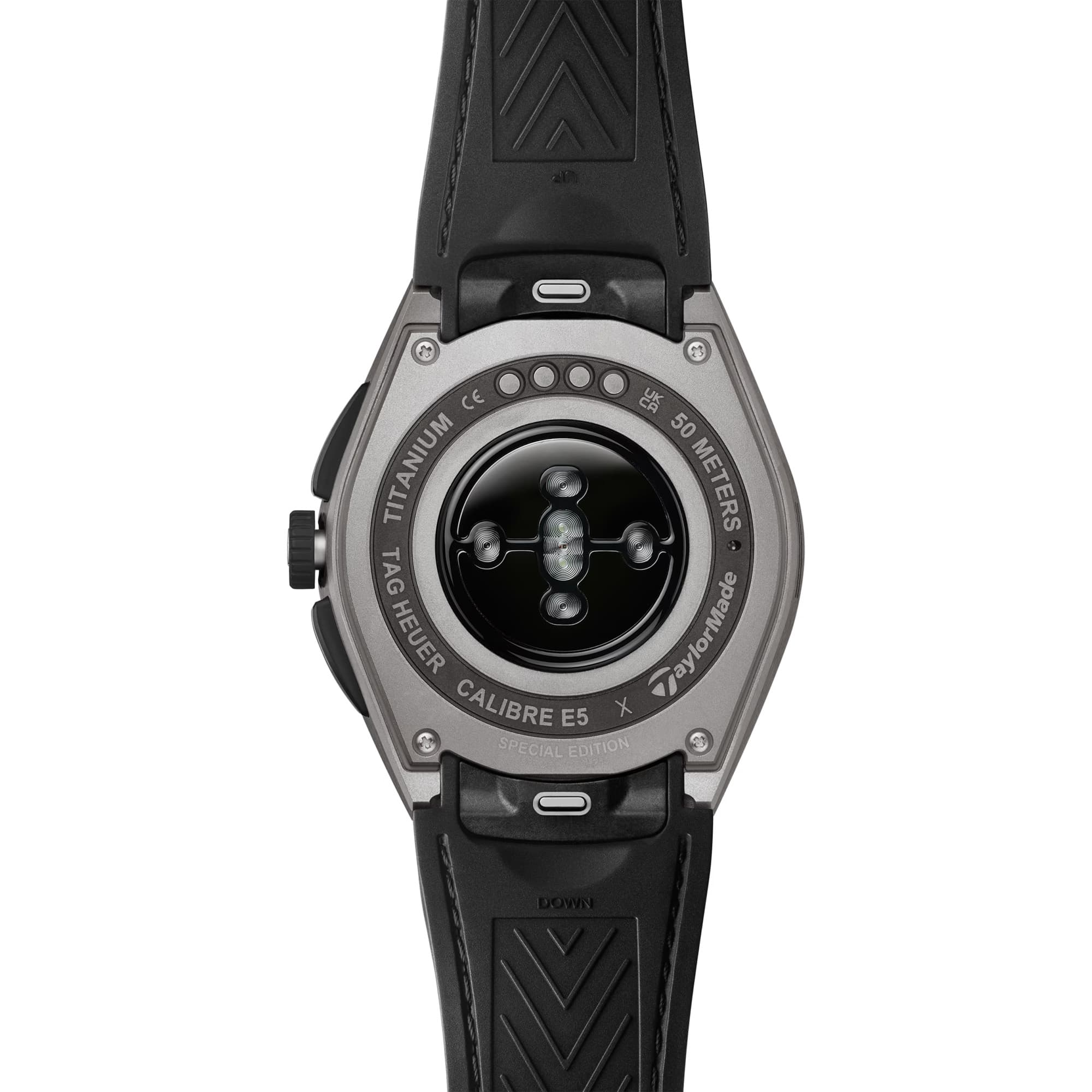 TAG Heuer Connected Calibre E5 x TaylorMade Edition SBT8A86.EB0421 shown from the case-back, displaying the sensor array and charging contacts. The black and blue strap is visible alongside the case-back detail.