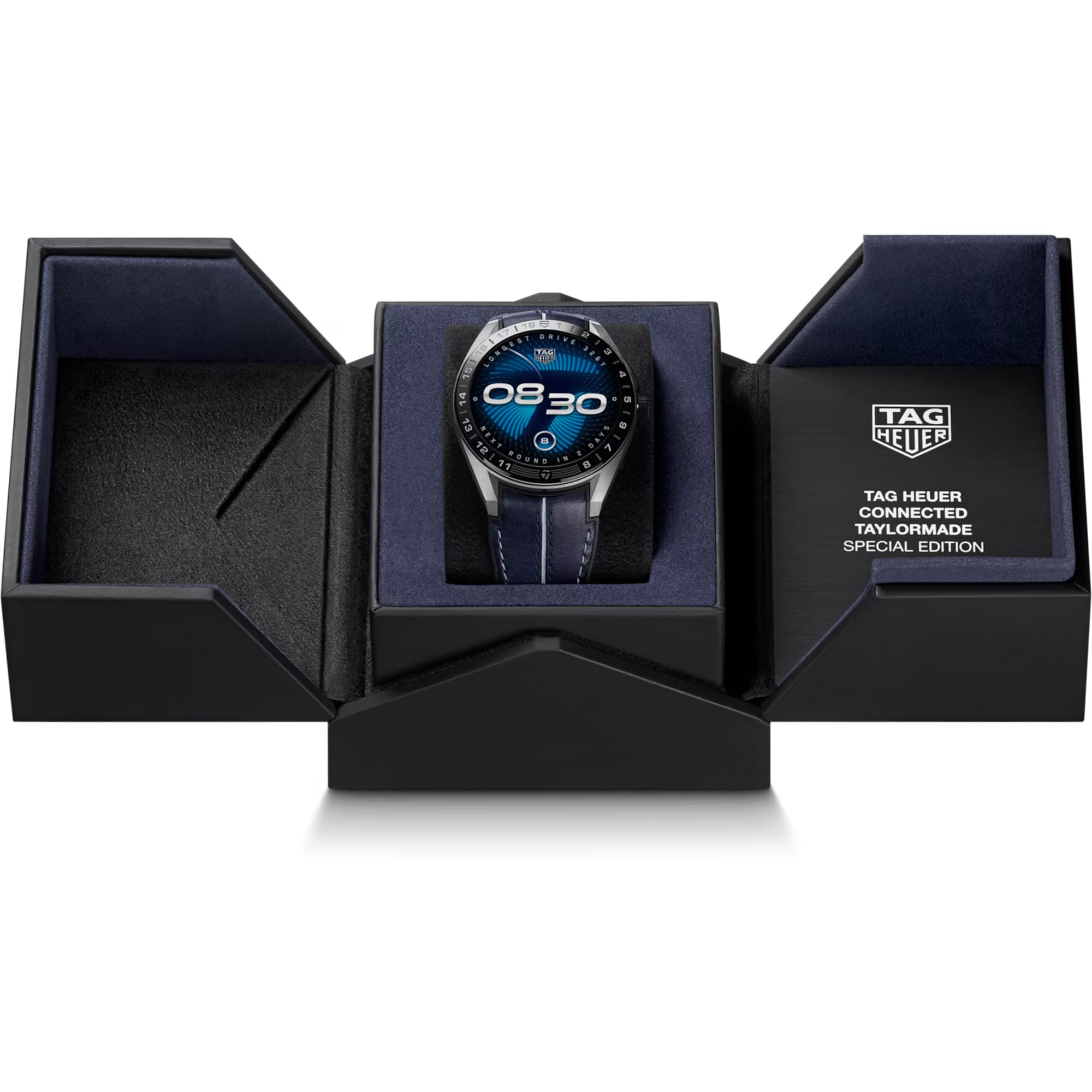 TAG Heuer Connected Calibre E5 x TaylorMade Edition SBT8A86.EB0421 presented in its packaging alongside the included complimentary strap and charging dock. The co-branded TAG Heuer and TaylorMade detailing is visible on the packaging.