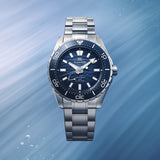 Close-up of the blue "Ushio" dial on the Grand Seiko Evolution 9 SLGB023 men's 40.8mm diver's watch, showing the gradient finish and power reserve indicator. LumiBrite is applied to the hands, indexes and bezel.