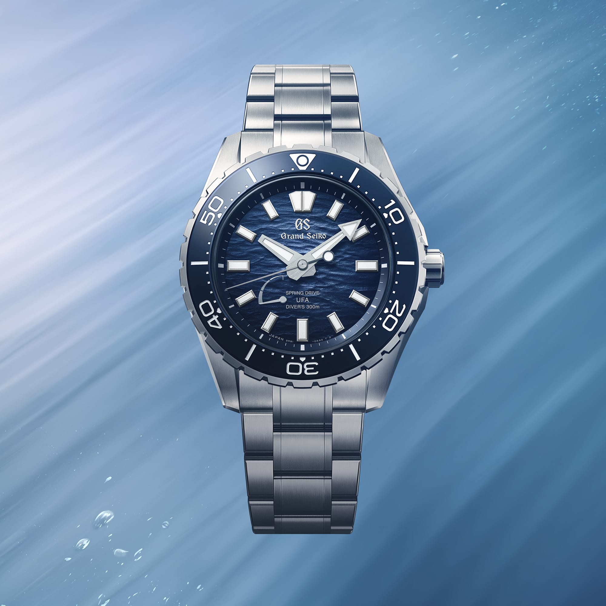 Close-up of the blue "Ushio" dial on the Grand Seiko Evolution 9 SLGB023 men's 40.8mm diver's watch, showing the gradient finish and power reserve indicator. LumiBrite is applied to the hands, indexes and bezel.