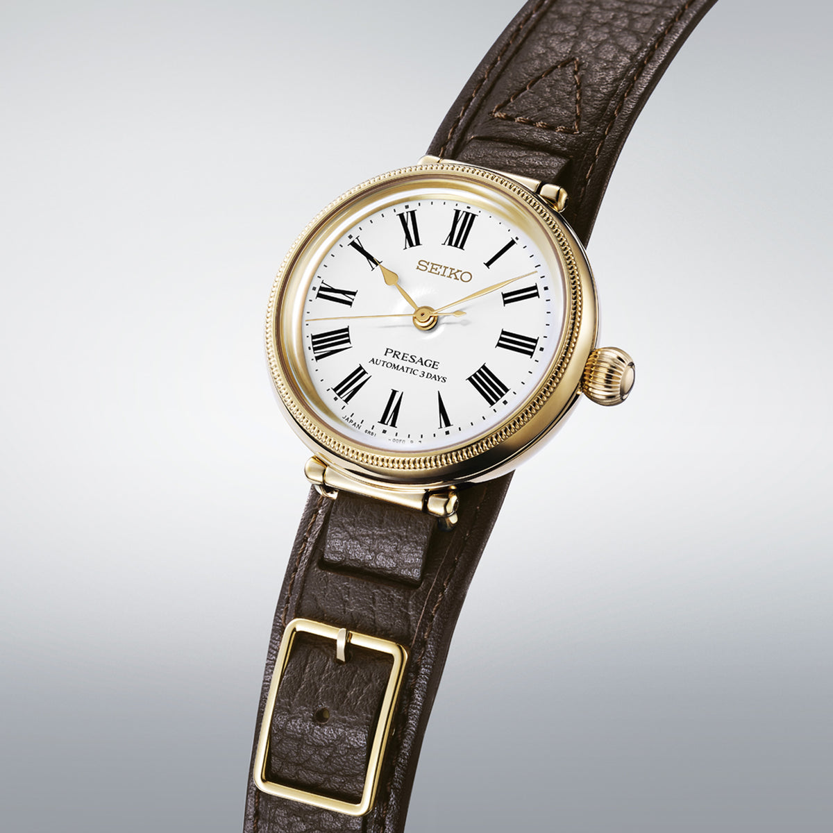 The Seiko Presage Automatic 35mm Limited Edition Watch SPB538J reveals the enamel dial's fine craftsmanship, Roman numerals and applied gold Seiko logo in close detail.