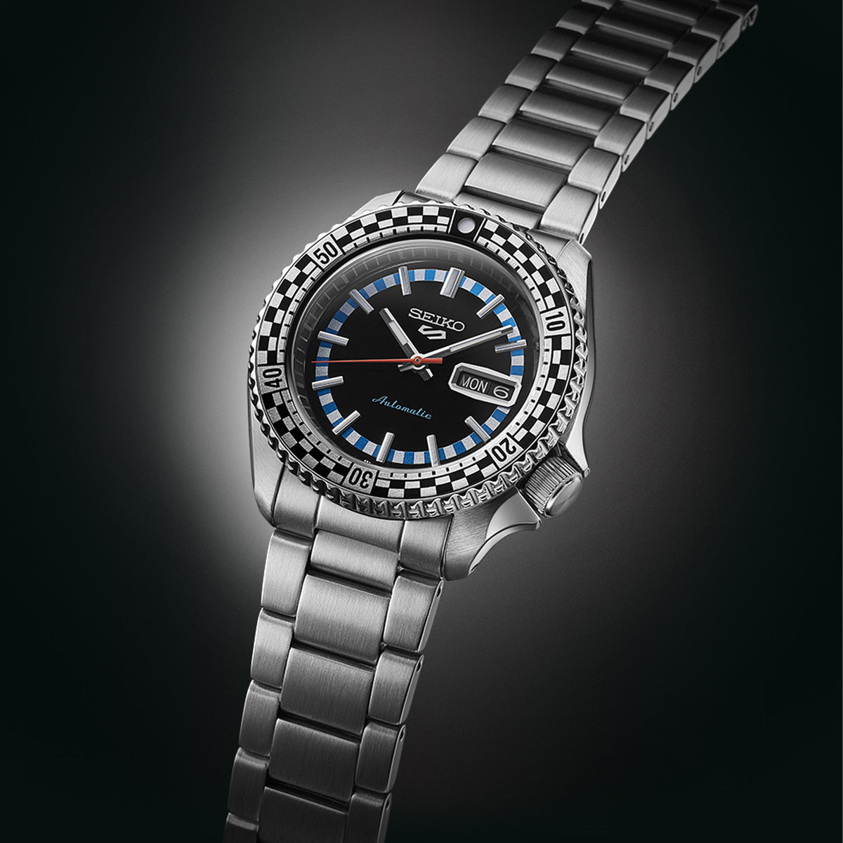 The Seiko 5 Sports SKX Series Men’s 42.50mm Watch SRPK67K shows the dial’s baton markers, vintage-style hands and day-date window. The checkered bezel insert sits around the dial.