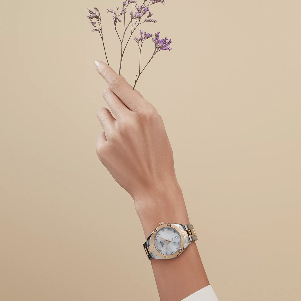 Tissot PR 100 Sport Chic 36mm T101.910.22.116.00 worn on wrist – white mother-of-pearl dial with diamond indexes, two-tone grey and rose gold PVD case and bracelet, elegant 36mm women's quartz watch shown on wrist