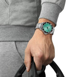 Tissot Seastar 1000 40mm T120.410.11.091.00 worn on wrist – turquoise dial, silver stainless steel case and bracelet, rotating dive bezel, 40mm sport watch presence shown on wrist