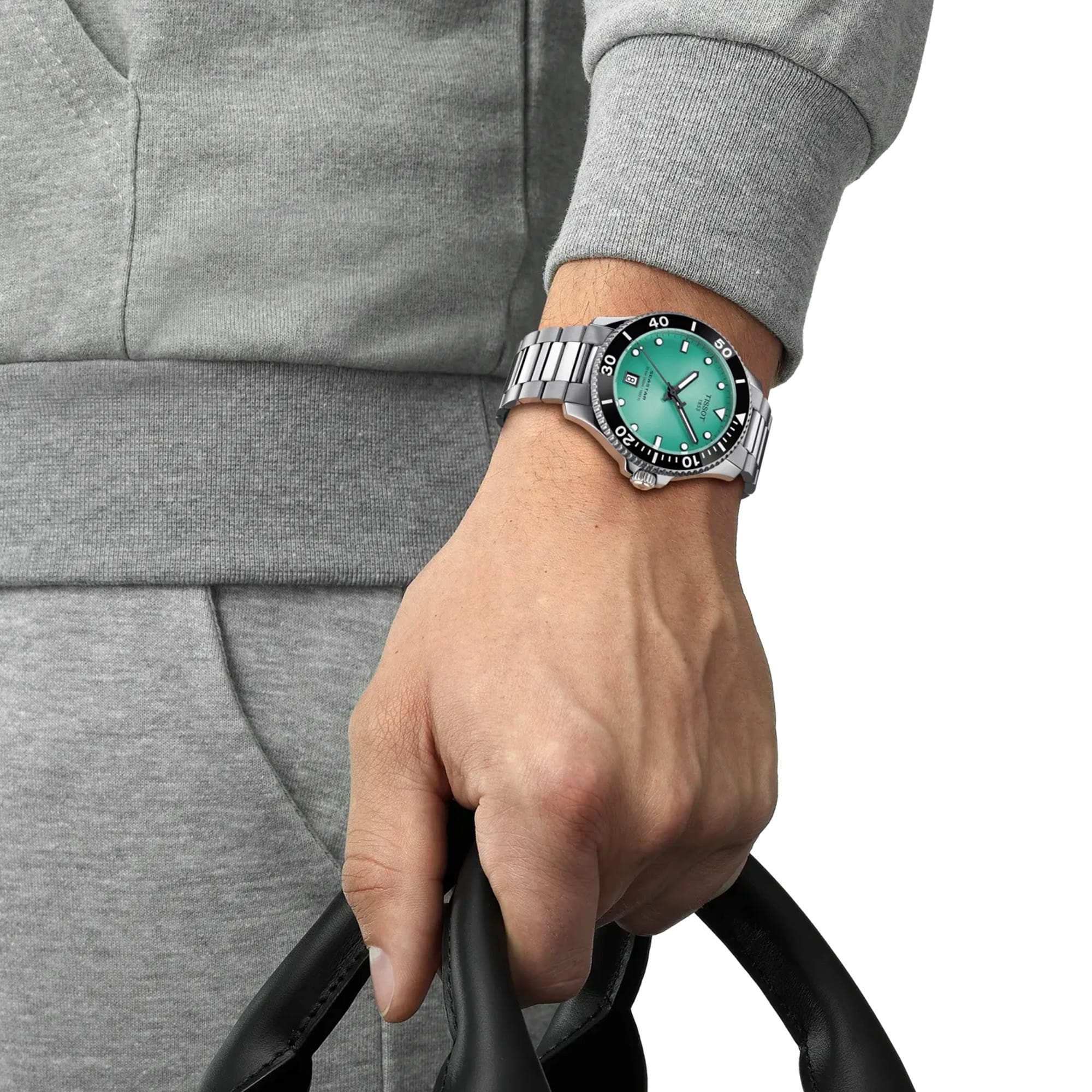 Tissot Seastar 1000 40mm T120.410.11.091.00 worn on wrist – turquoise dial, silver stainless steel case and bracelet, rotating dive bezel, 40mm sport watch presence shown on wrist