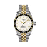 Tissot PRS16 Powermatic 80 watch with a two-tone stainless steel and gold bracelet, featuring a cream-colored dial and a black rotating bezel.