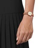 Tissot Desir 28mm T152.010.33.118.01 worn on wrist – white mother-of-pearl dial with Roman numerals, rose gold PVD case and bracelet, elegant 28mm women’s quartz watch shown on wrist