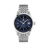 Tissot Visodate 39mm T157.407.11.041.00 front view – deep blue dial, silver stainless steel case, Dauphine hands, index hour markers, date window, grey grains of rice stainless steel bracelet