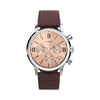 The Timex Marlin Chronograph TW2W51400 features a rose gold-tone sunburst dial with three chronograph sub-dials and Arabic numeral markers. A date window sits between the 4 and 5 o'clock positions.