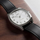 The Timex Marlin Chatham Automatic 36mm Watch TW2Y84300 is shown. The white dial and black leather strap bring a mid-century look to relaxed everyday outfits.