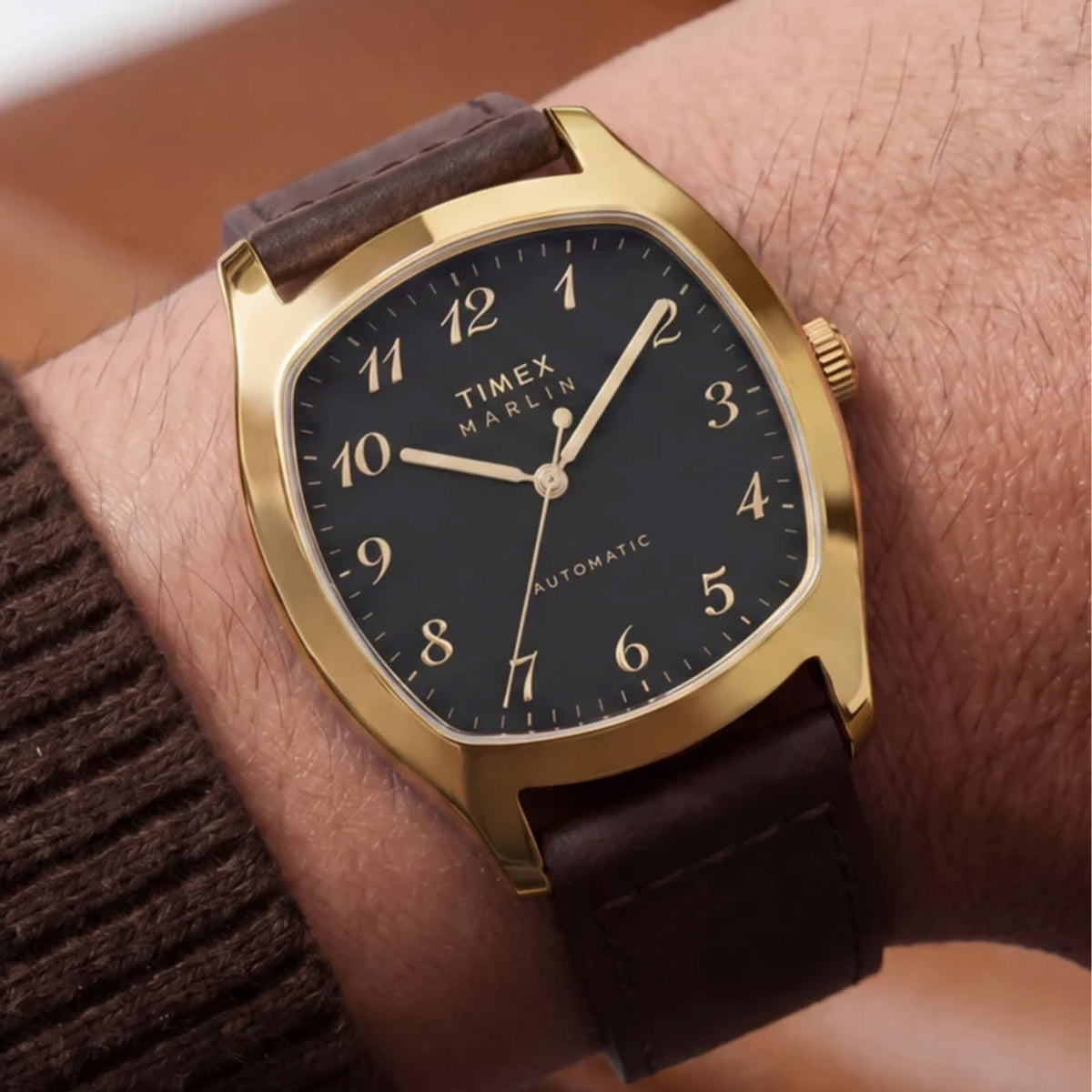 The Timex Marlin Chatham Automatic 36mm Watch TW2Y84500 pairs its compact 36mm gold-tone case with a brown leather strap on the wrist. The size sits comfortably on a wide range of wrists.