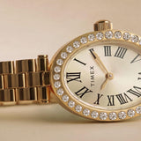 The Timex Cavatina Dress Watch TW2Y90100 makes a delicate, eye-catching everyday accessory, suiting both casual and dressier occasions. The champagne dial and crystal bezel bring a touch of glamour to any outfit.