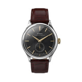 The Timex Waterbury Traditional Quartz 39mm Watch TW2Y92100 features a textured black dial with a pronounced gold-tone handset and matching hour markers. A sub-second dial sits at 6 o'clock.
