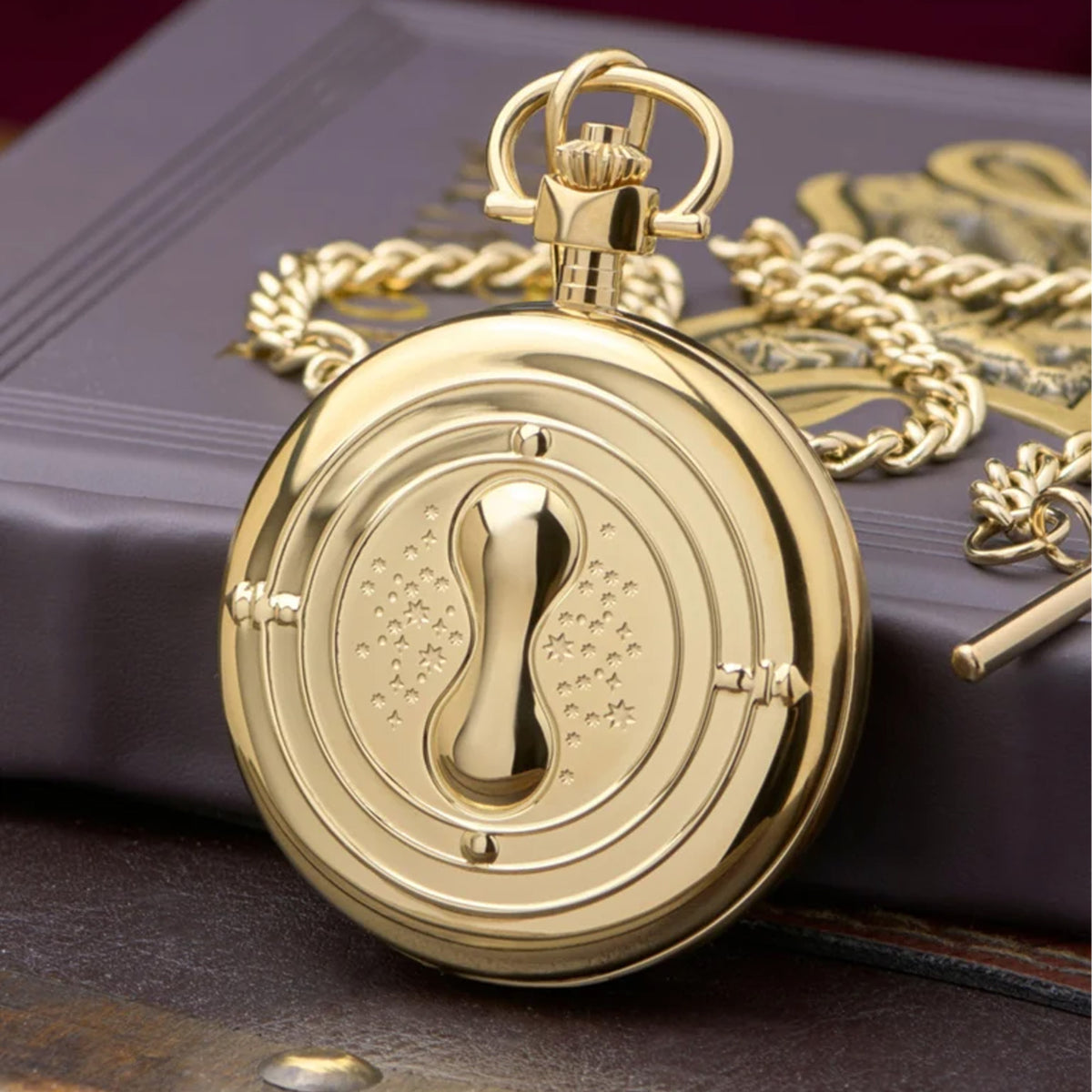The Timex x Harry Potter Time Turner 48.5mm Pocket Watch TW2Y99600 has a case back engraved with the Harry Potter and Timex logos. A battery-powered quartz analog movement sits inside the case.