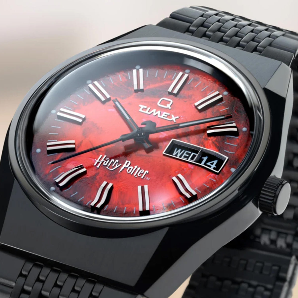 The Timex x Harry Potter Sorcerer’s Stone 38mm Quartz Watch TW2Y99700 has a fiery red dial inspired by the Sorcerer’s Stone and a red wand-shaped second hand. A day and date window sits at 3 o’clock inside the black IP-coated case.