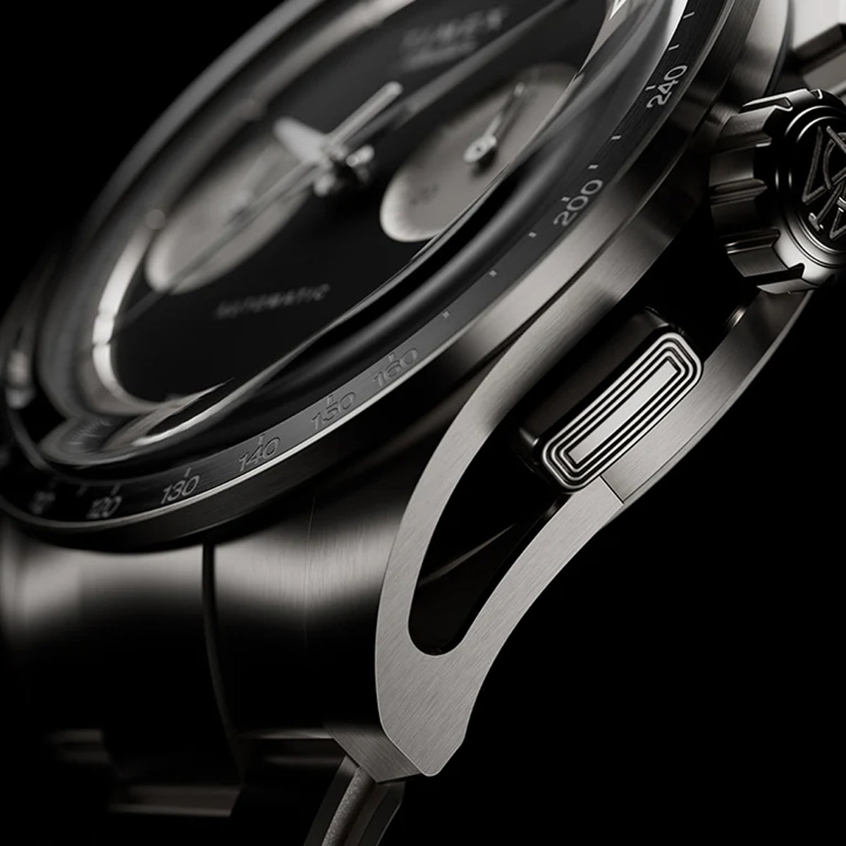 The Timex Atelier Chronograph Automatic M1a Ti Men's 42mm Watch TW6A02700 highlights the skeletonized case architecture and tachymeter bezel from this angle.