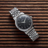The Timex Marlin Quartz 34mm Watch TW6A04200 suits everyday elegance, worn day-to-day. The black sunray dial and stainless steel bracelet bring retro 1960s charm to any outfit.