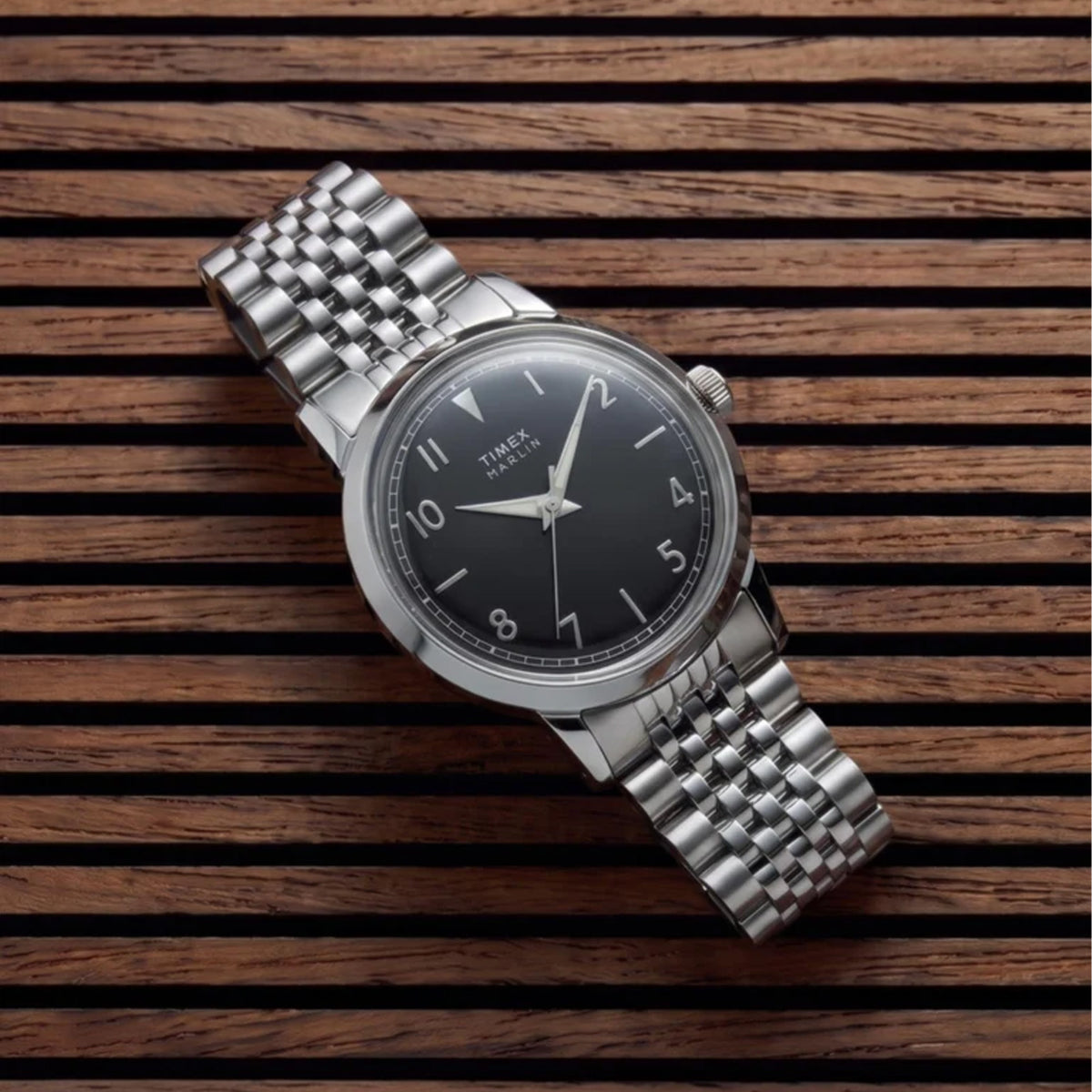 The Timex Marlin Quartz 34mm Watch TW6A04200 suits everyday elegance, worn day-to-day. The black sunray dial and stainless steel bracelet bring retro 1960s charm to any outfit.
