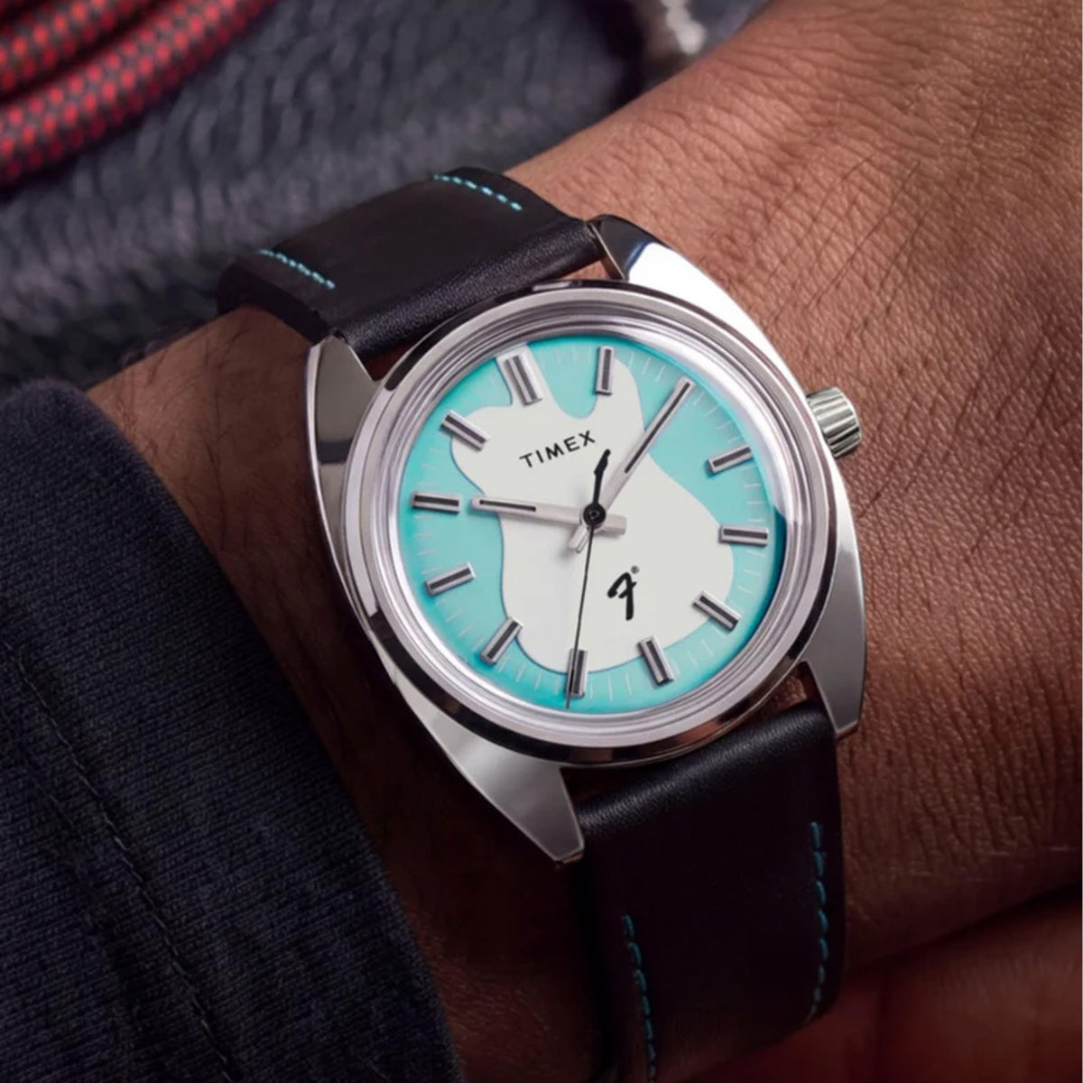 The Timex x Fender Quartz 37mm Watch TWG068900 pairs its silver-tone stainless steel case with a black leather strap with turquoise stitching. The compact 37mm size sits comfortably on most wrists.