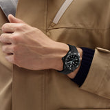 TAG Heuer Aquaracer Professional 200 Solargraph WBP1112.FT6199 shown worn on the wrist, illustrating the case proportions and black rubber strap fit. The black dial stands out against the sleeve in frame.