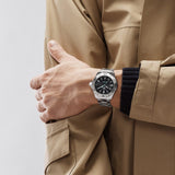 TAG Heuer Aquaracer Professional 200 Solargraph WBP1114.BA0000 shown worn on the wrist, illustrating the case proportions and steel bracelet fit. The black dial stands out against the sleeve in frame.