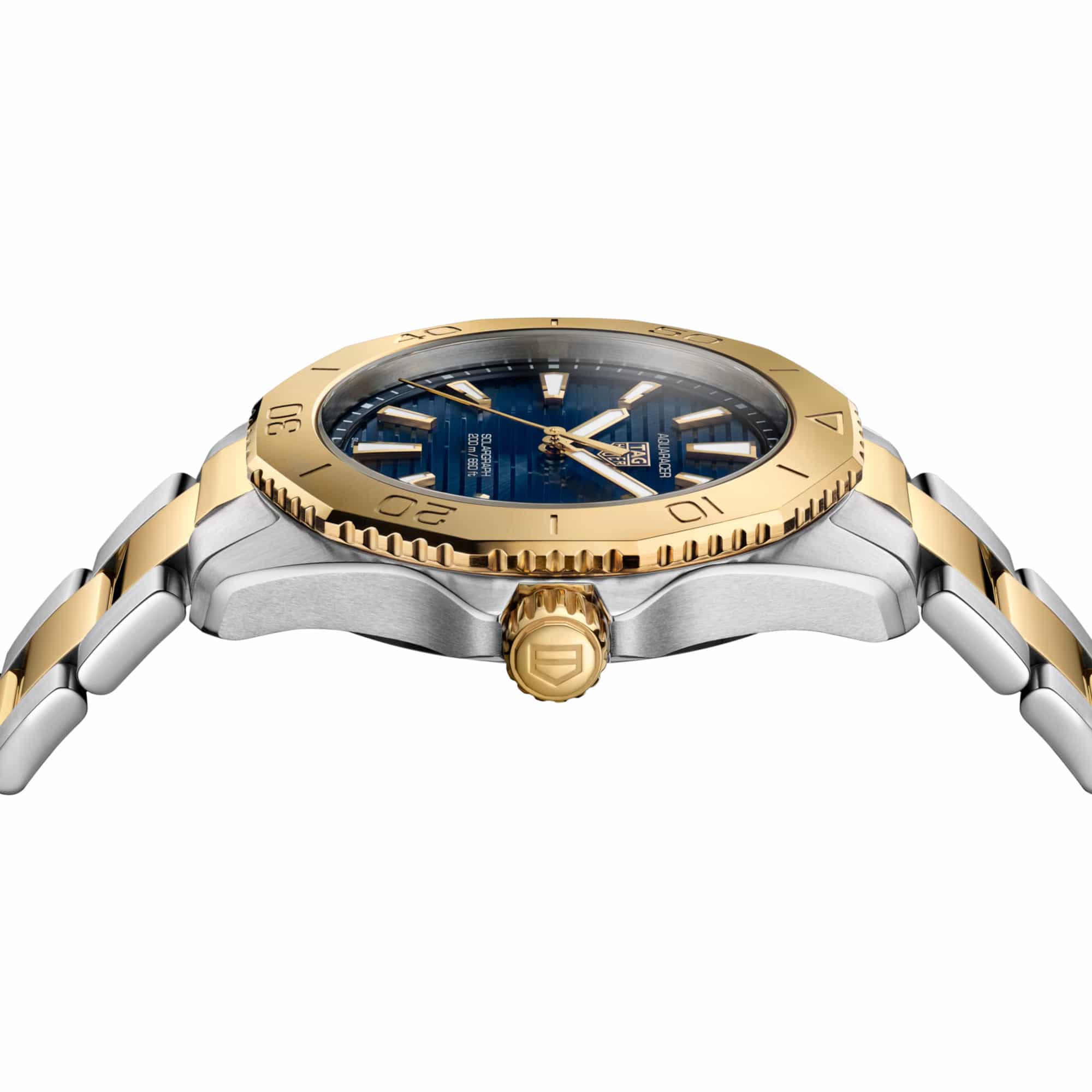 TAG Heuer Aquaracer Professional 200 Solargraph WBP1120.BB0002 photographed at an angle highlighting the blue dial's gold-plated hands and unidirectional bezel. The two-tone bracelet curves away from the lugs, showing its link construction.
