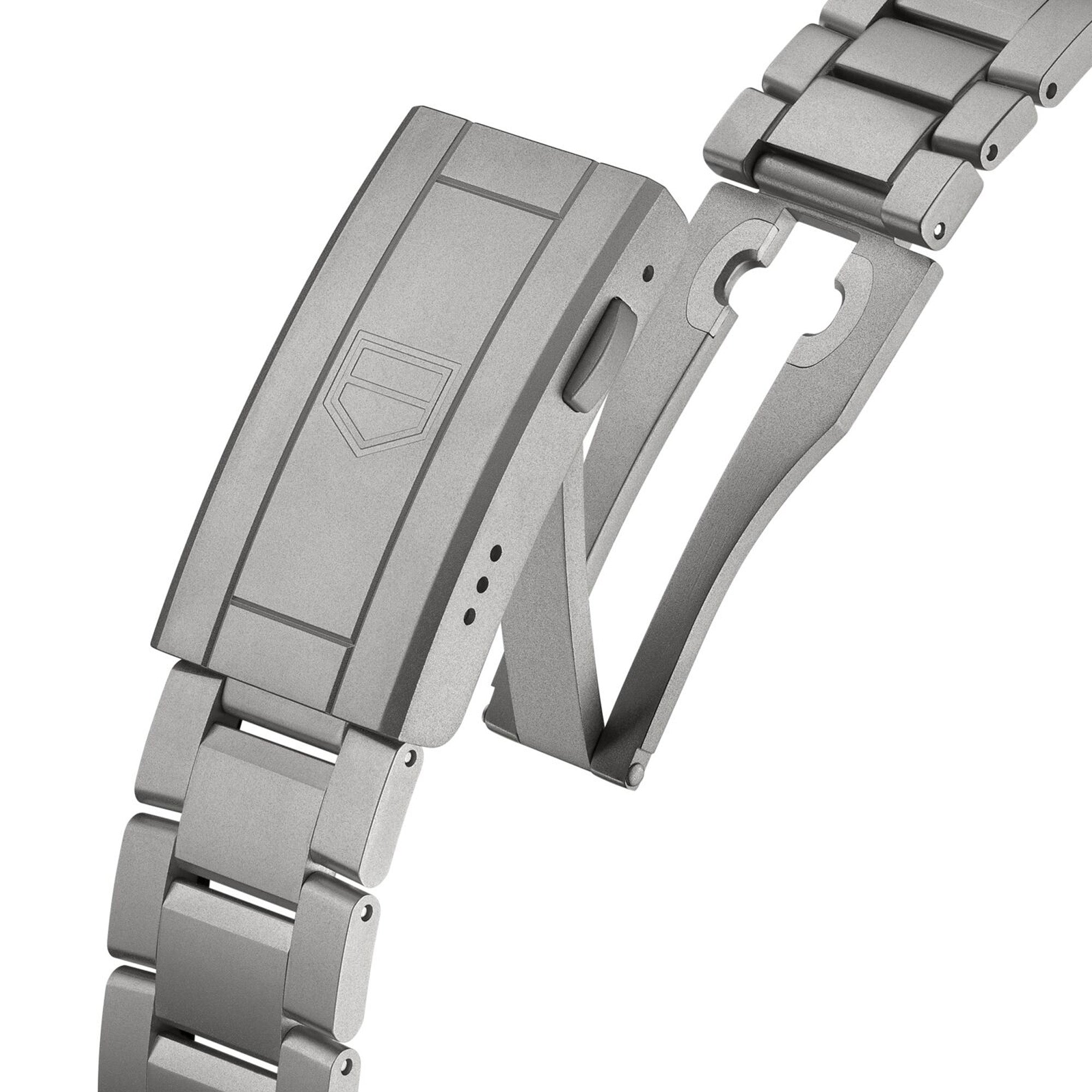 Close-up of the TAG Heuer Aquaracer Professional 200 Solargraph WBP1184.BF0008 titanium folding clasp with engraved TAG Heuer shield logo and brushed titanium bracelet links.