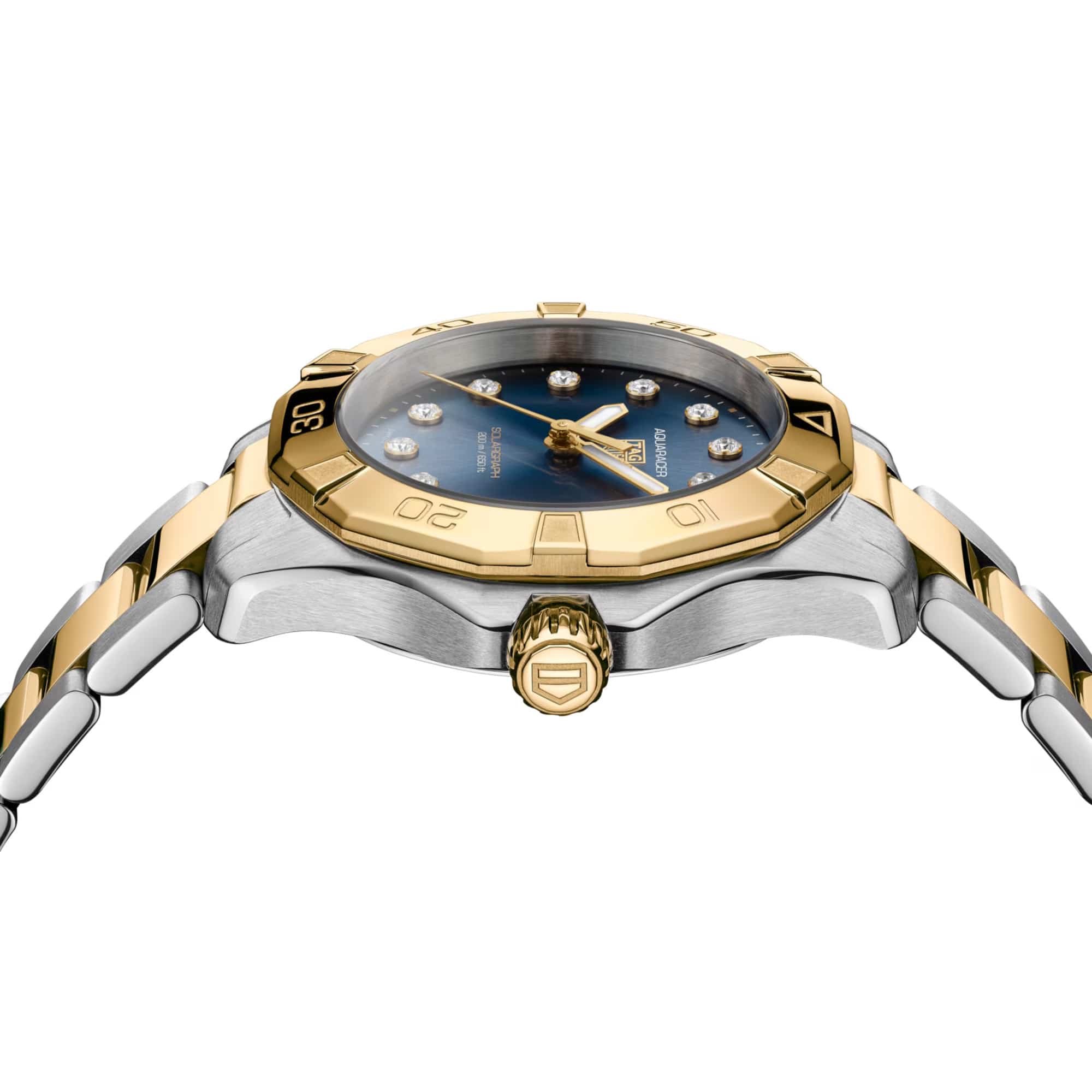 TAG Heuer Aquaracer Professional 200 Solargraph WBP1323.BB0004 photographed from a side profile, showing the case thickness and screw-down gold-plated crown. The two-tone bracelet and bezel are visible together in frame.