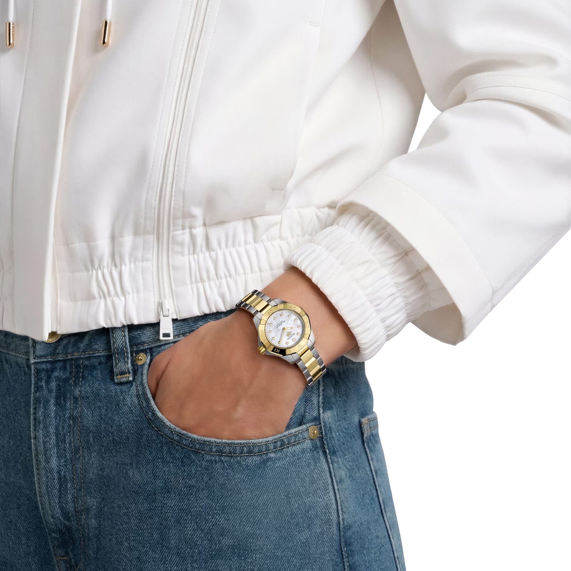 TAG Heuer Aquaracer Professional 100 Solargraph WBP1420.BB0006 shown worn on the wrist, illustrating the case proportions and two-tone bracelet fit. The mother-of-pearl dial stands out against the sleeve in frame.