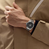 TAG Heuer Aquaracer Professional 200 Date WBP2110.BA0627 shown worn on the wrist, illustrating the case proportions and steel bracelet fit. The black dial stands out against the sleeve in frame.