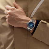 TAG Heuer Aquaracer Professional 200 Date WBP2111.BA0627 shown worn on the wrist, illustrating the case proportions and steel bracelet fit. The blue dial stands out against the sleeve in frame.
