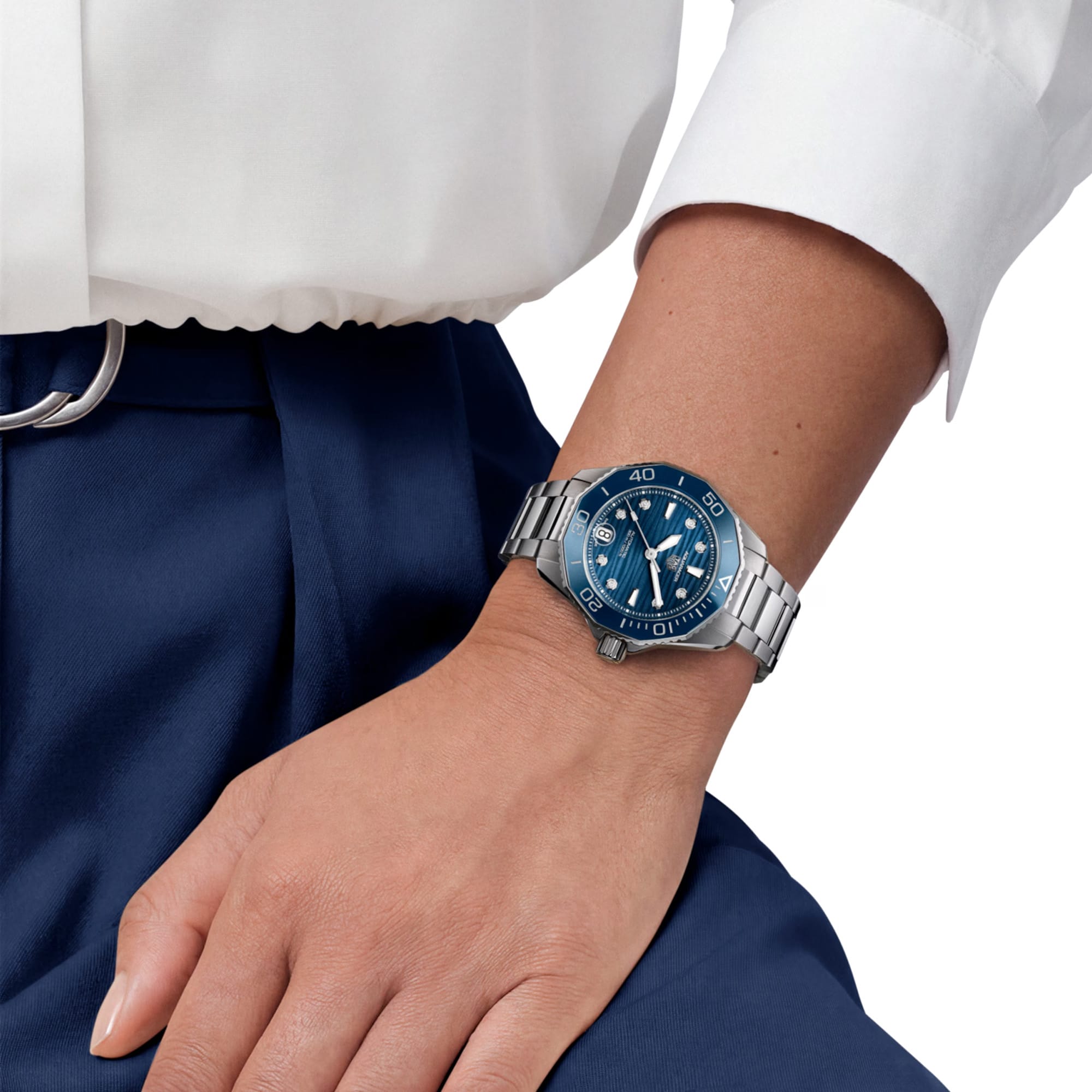 TAG Heuer Aquaracer Professional 300 Date WBP231B.BA0618 shown worn on the wrist, illustrating the case proportions and steel bracelet fit. The blue dial stands out against the sleeve in frame.