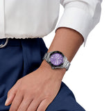 TAG Heuer Aquaracer Professional 300 Date WBP231M.BA0618 shown worn on the wrist, illustrating the case proportions and steel bracelet fit. The purple dial stands out against the neutral tone of the sleeve in frame.