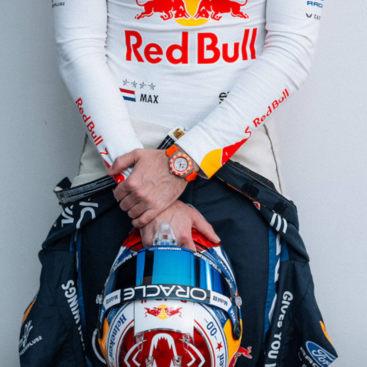TAG Heuer Formula 1 Solargraph WBY111H.FT8128 shown worn on the wrist, illustrating the case proportions and orange rubber strap fit. The grey dial and orange accents stand out against the sleeve in frame.