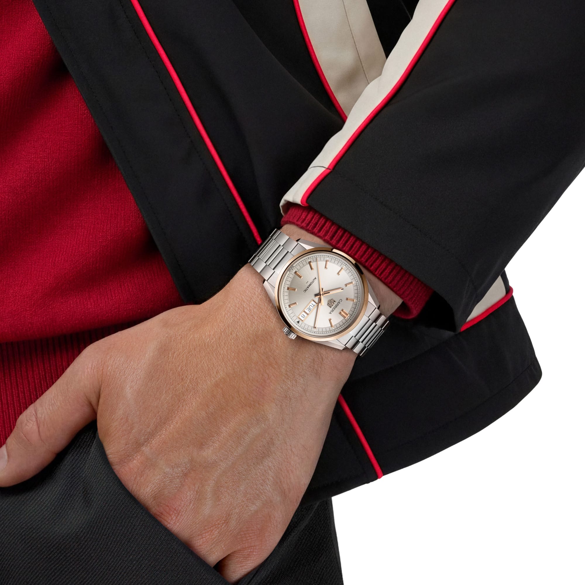TAG Heuer Carrera Day-Date WDA2150.BA0043 shown worn on the wrist, illustrating the case proportions and steel bracelet fit. The champagne dial stands out against the dark jacket sleeve in frame.