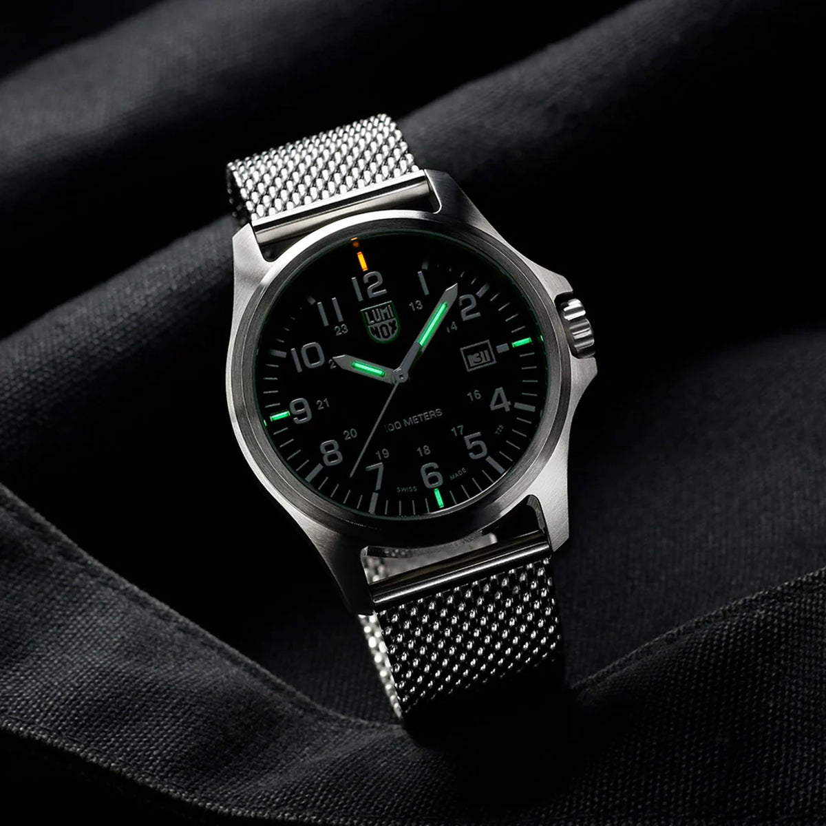 Luminox Patagonia Steel Men's 43mm Quartz Watch X2.2501.M shown in a relaxed everyday setting. This Luminox G-Collection watch features a black dial, a stainless steel case and a stainless steel mesh bracelet.